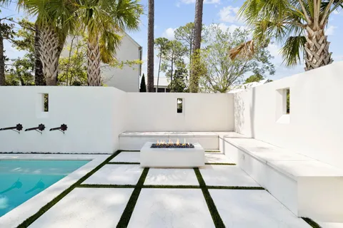 a view of a white house with a yard and plants