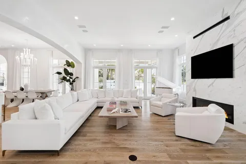 a kitchen with stainless steel appliances a stove a microwave a sink and white cabinets