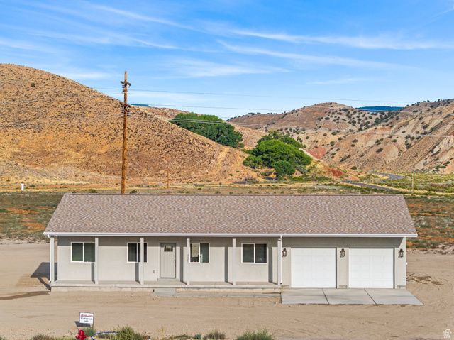 701 South Black Knl Road, Unit 4 Sigurd, UT 84657 - Photo 1 of 1 View of front of home featuring a porch, roof with shingles, a mountain view, an attached garage, and concrete driveway