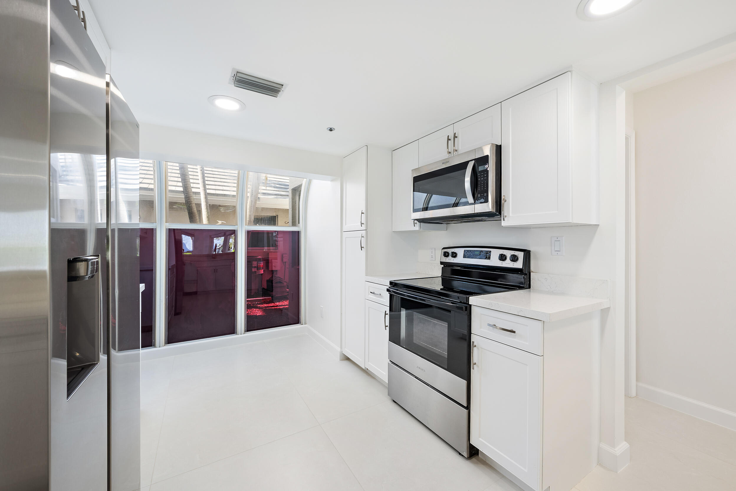 1000 North Us Highway, Unit 652 Jupiter, FL 33477 - Photo 11 of 64 a kitchen with stainless steel appliances granite countertop a stove and a refrigerator