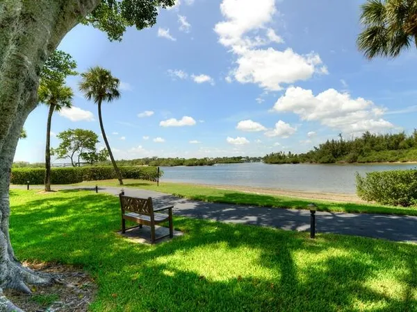 a swimming pool with outdoor seating and lake