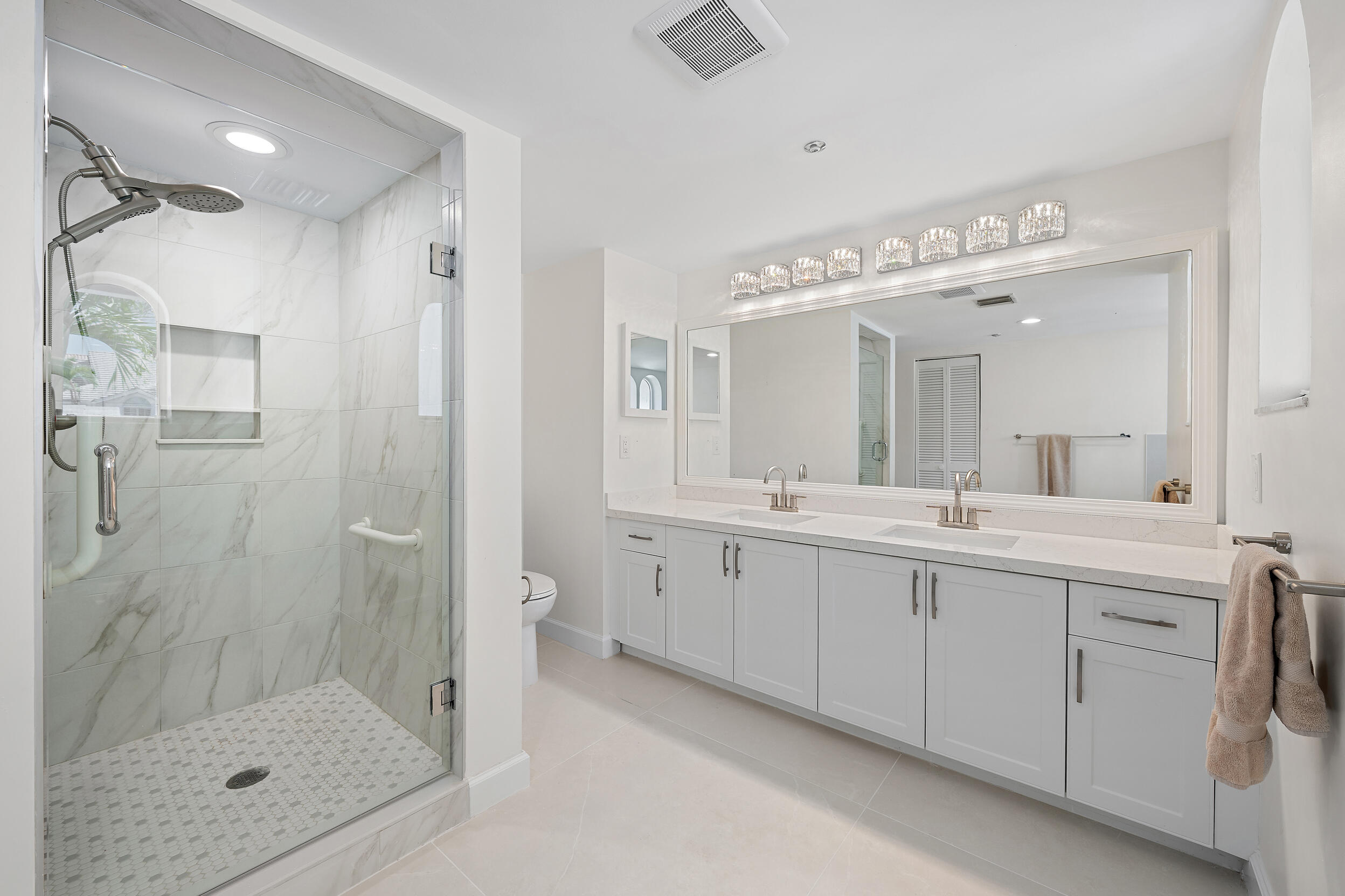 1000 North Us Highway, Unit 652 Jupiter, FL 33477 - Photo 15 of 64 a spacious bathroom with a shower sink and mirror