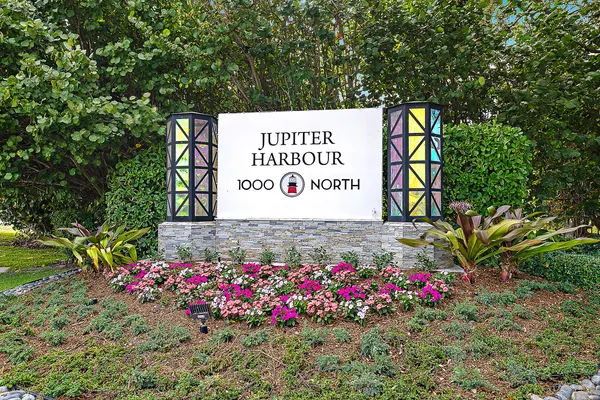 a sign that is in front of flowers