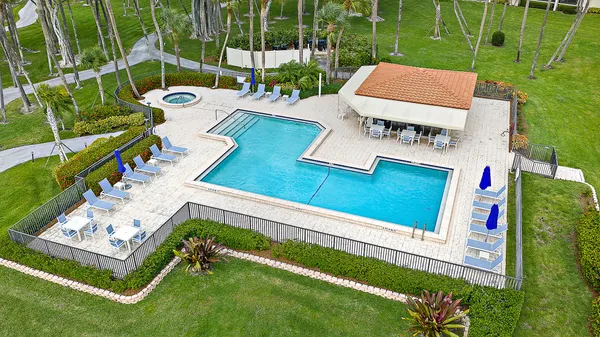 swimming pool view with a seating space