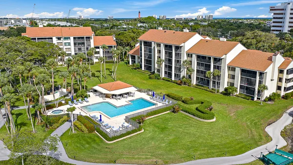 an aerial view of a house with yard swimming pool and outdoor seating