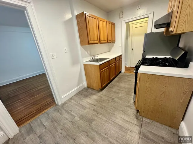 a kitchen with granite countertop a stove and a refrigerator