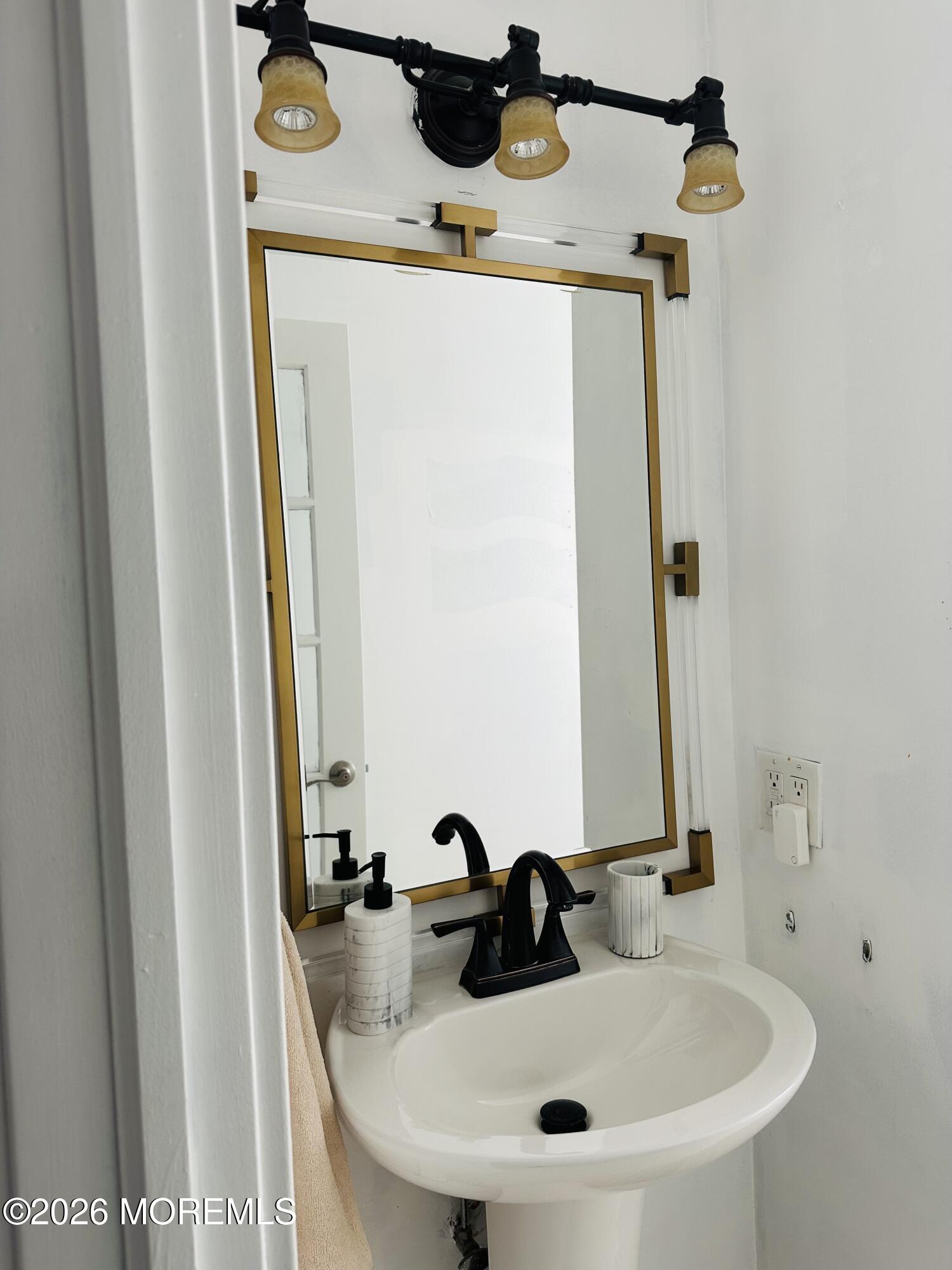 175 Delaware Avenue Oakhurst, NJ 07755 - Photo 12 of 24 a bathroom with a sink and a mirror