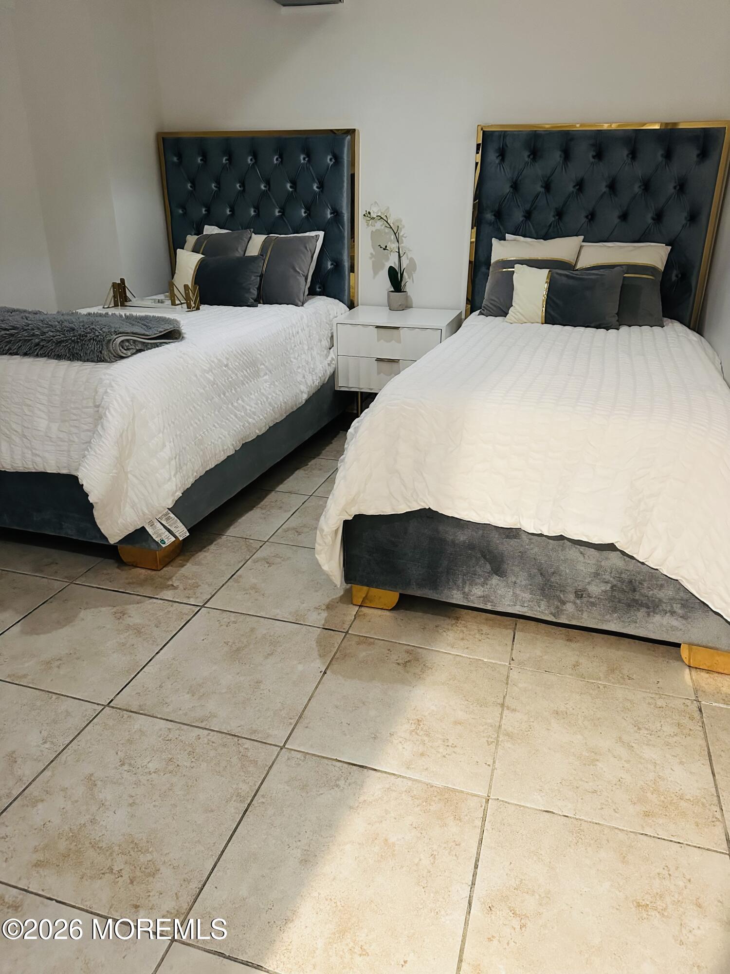 175 Delaware Avenue Oakhurst, NJ 07755 - Photo 19 of 24 a bedroom with a bed and a potted plant on dresser