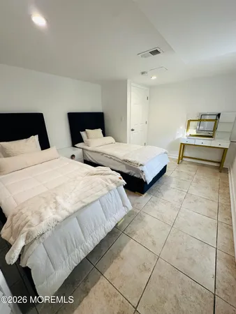 a bedroom with a bed and a couch