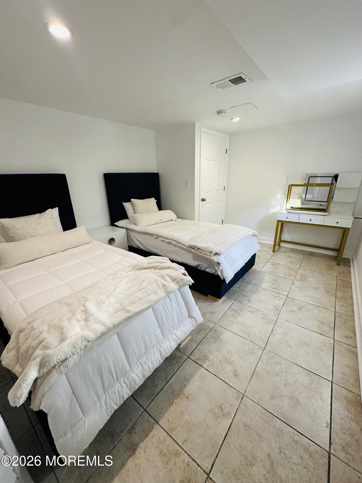 175 Delaware Avenue Oakhurst, NJ 07755 - Photo 20 of 24 a bedroom with a bed and a couch