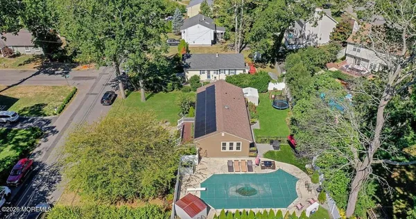 an aerial view of a house with a yard and garden