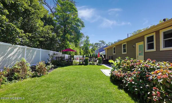 a backyard of a house with lots of green space and garden