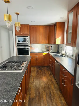 a kitchen with a stove a sink and a microwave