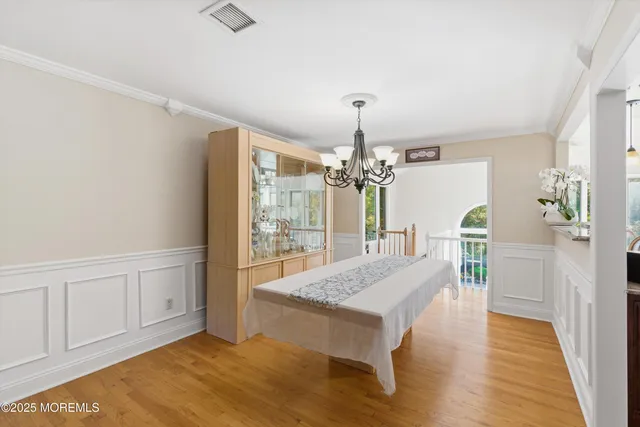 a kitchen with stainless steel appliances kitchen island granite countertop a dining table chairs and granite counter tops