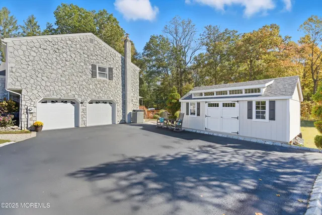 a kitchen with stainless steel appliances granite countertop a refrigerator a sink a stove and a wooden floors