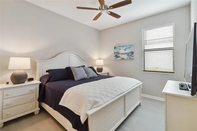 a bathroom with a sink a toilet a mirror and shower curtain