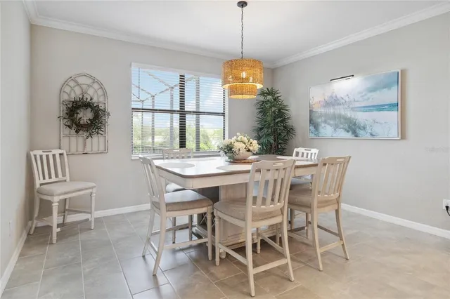 a dining room with furniture a chandelier and window