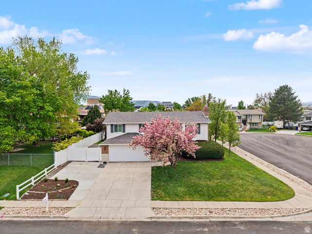 523 Mountain View Road Centerville, UT 84014 - Photo 27 of 33 View of front facade with concrete driveway, a shingled roof, and a residential view