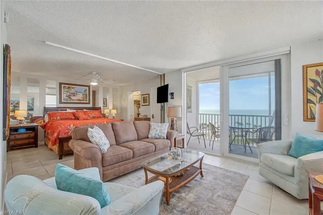 a bed room with furniture and a large window