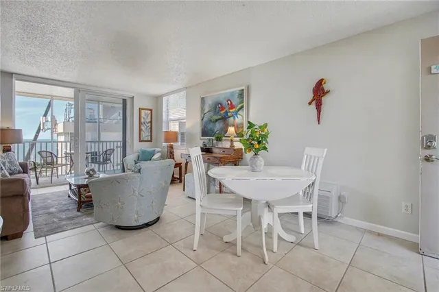 a living room with furniture a flat screen tv and a dining table