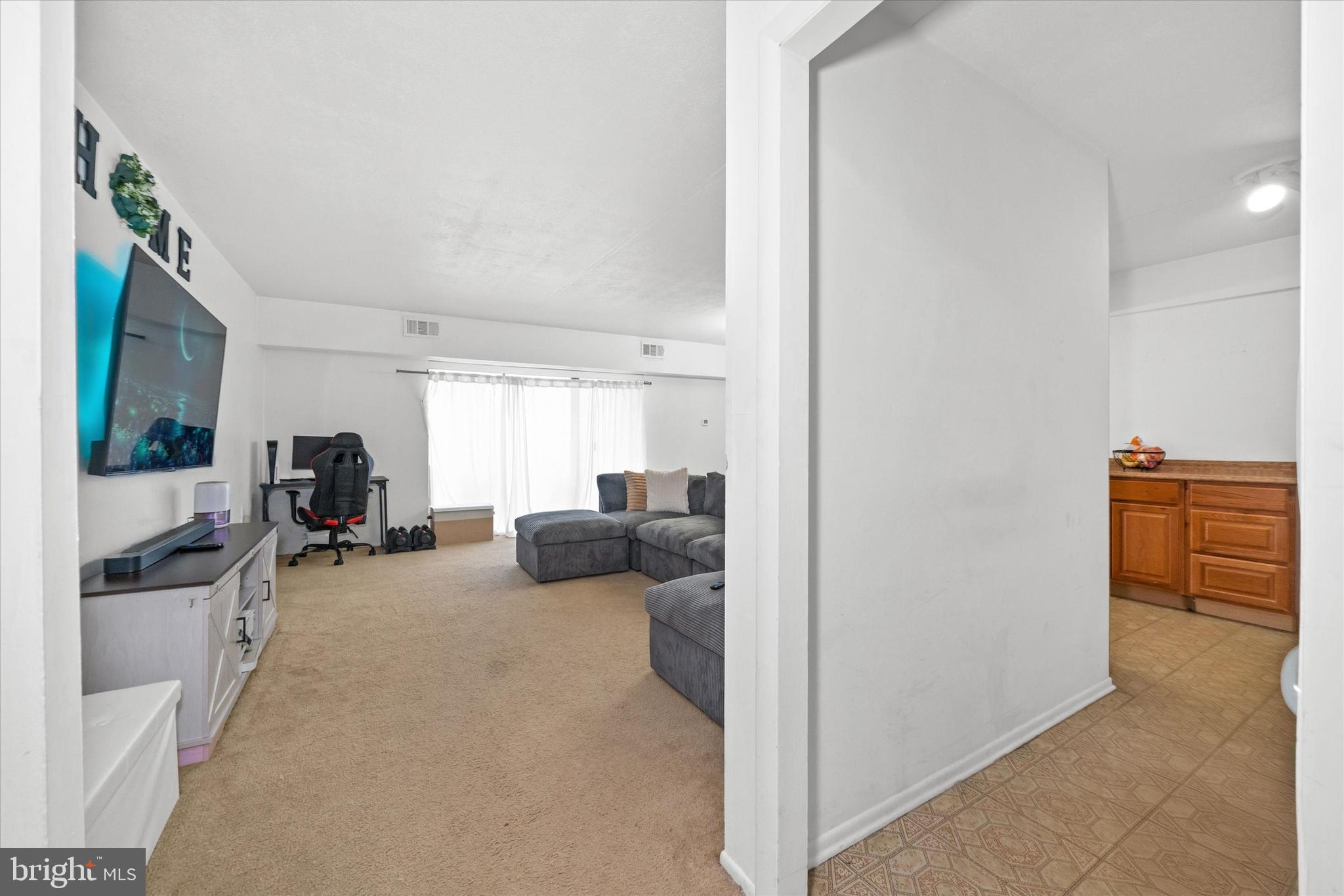 84 Welsh Tract Road, Unit 108 Newark, DE 19713 - Photo 3 of 14 a living room with furniture and a flat screen tv