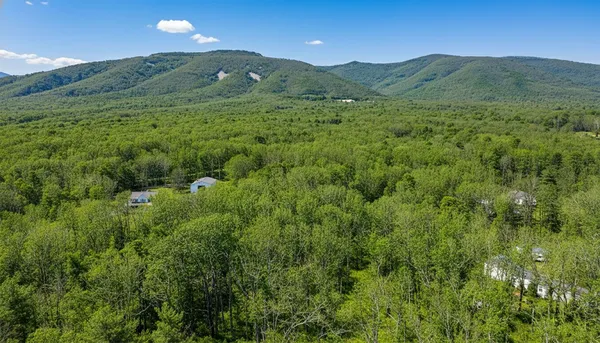 a view of a lush green hillside and a building