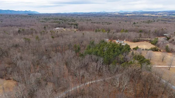 an aerial view of mountain with trees in the background