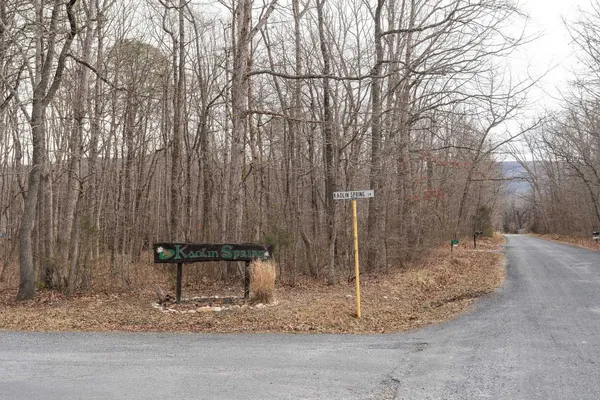 a wooden bench sitting in the middle of a yard
