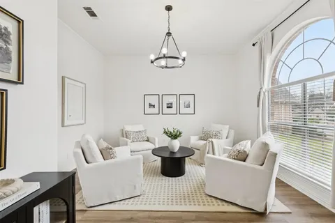 a living room with furniture a table and a window