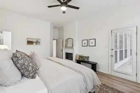 a bedroom with a large bed and a chandelier