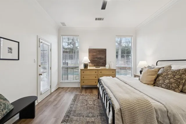 a bedroom with a large bed and a flat screen tv