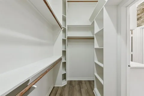 a view of walk in closet with empty racks