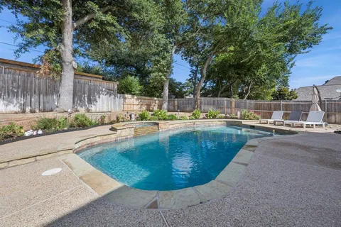 a front view of a house with swimming pool having outdoor seating