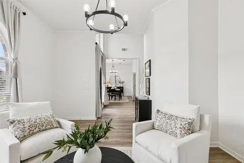 a living room with furniture and a chandelier