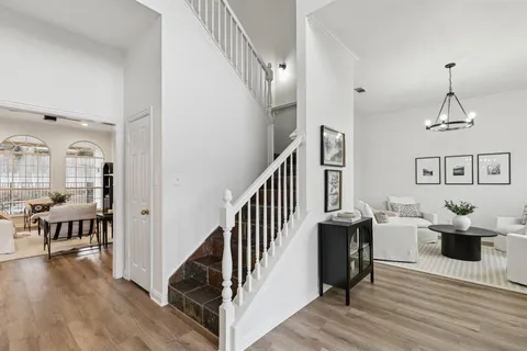 a view of a livingroom with furniture and hardwood floor