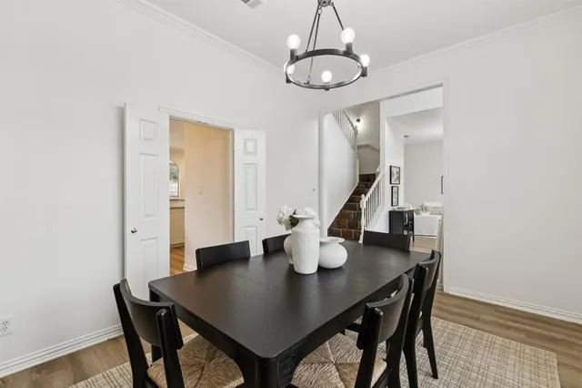 a view of a dining room with a table and chairs