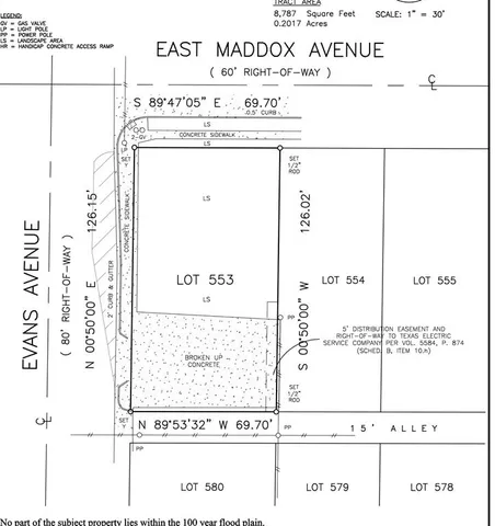 a front view of a building with a garden