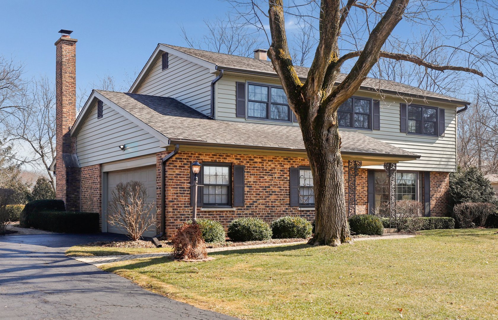 303 Roberts Road Inverness, IL 60067 - Photo 1 of 48 a front view of a house with yard and tress