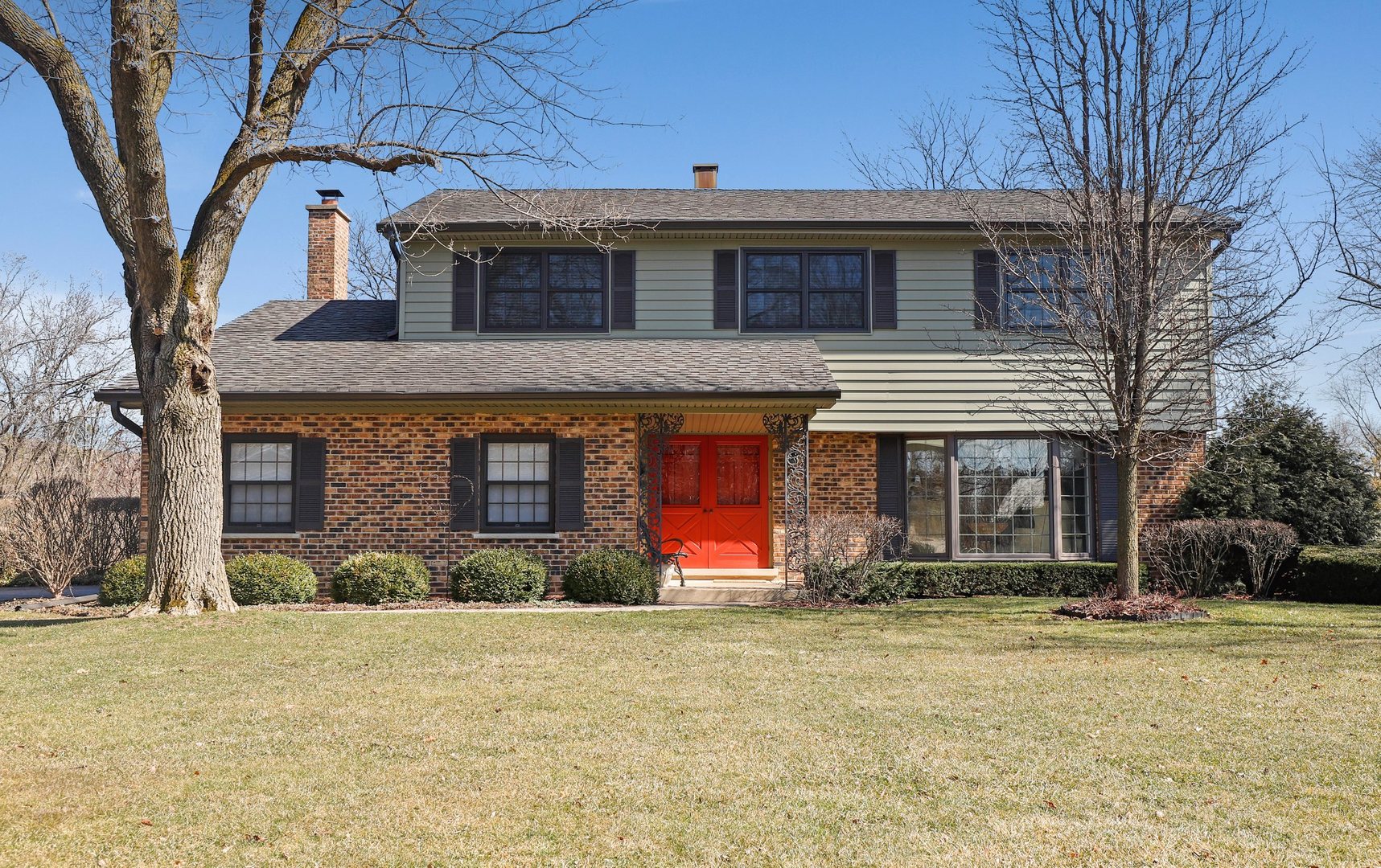 303 Roberts Road Inverness, IL 60067 - Photo 2 of 48 a front view of a house with large yard and large tree