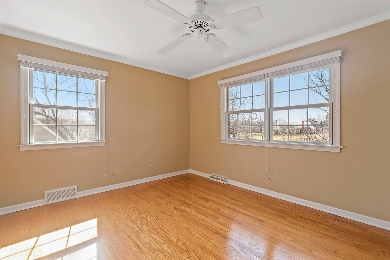 303 Roberts Road Inverness, IL 60067 - Photo 28 of 48 a view of empty room with wooden floor and fan