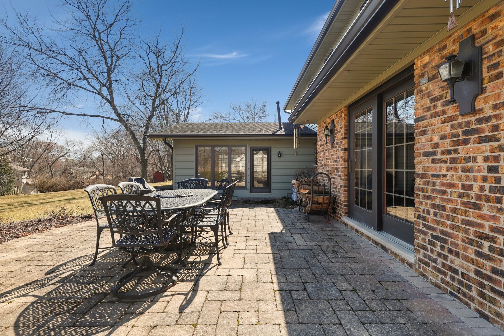 303 Roberts Road Inverness, IL 60067 - Photo 37 of 48 a view of a patio with table and chairs and floor to ceiling window