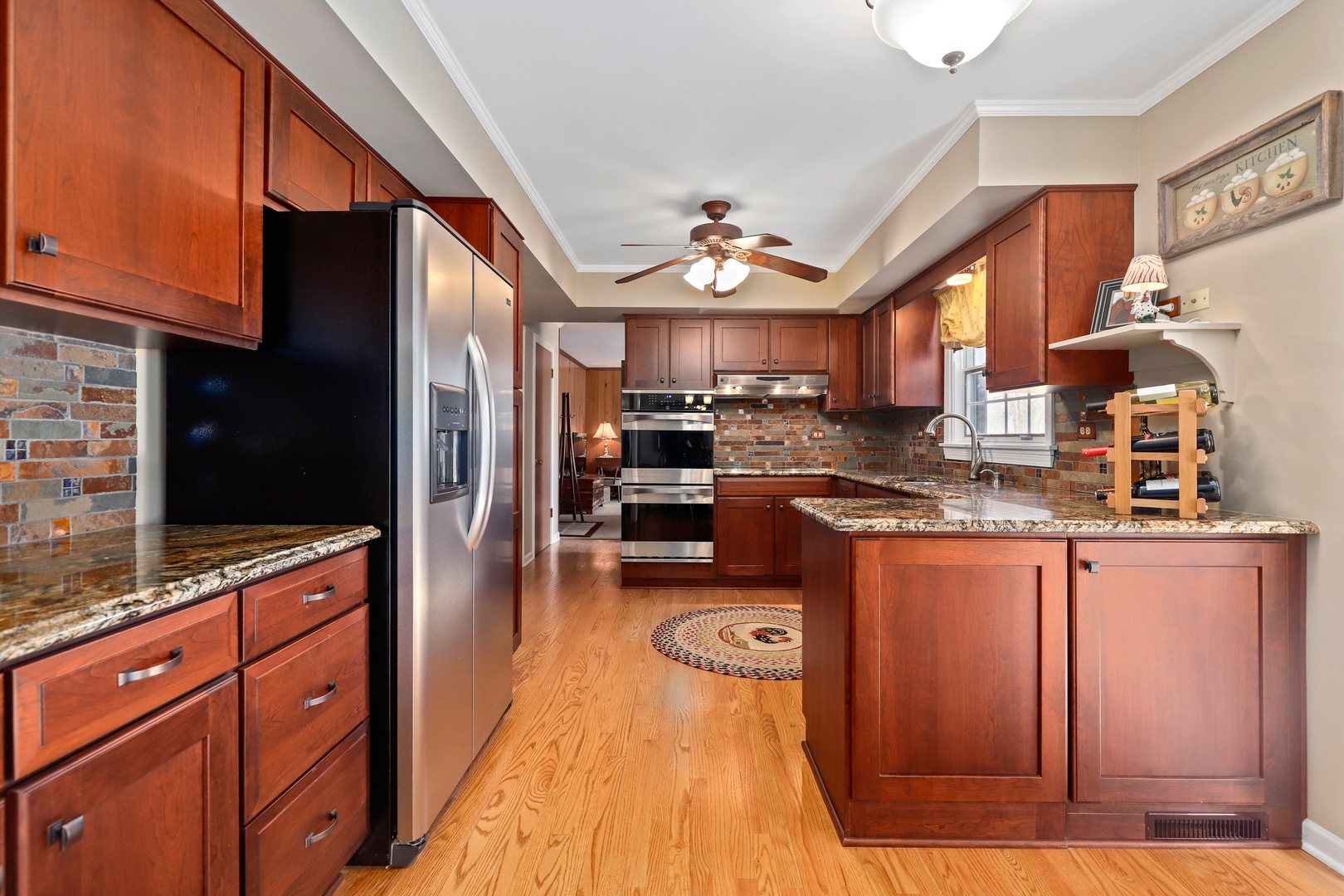 303 Roberts Road Inverness, IL 60067 - Photo 8 of 48 a kitchen with granite countertop stainless steel appliances and wooden cabinets