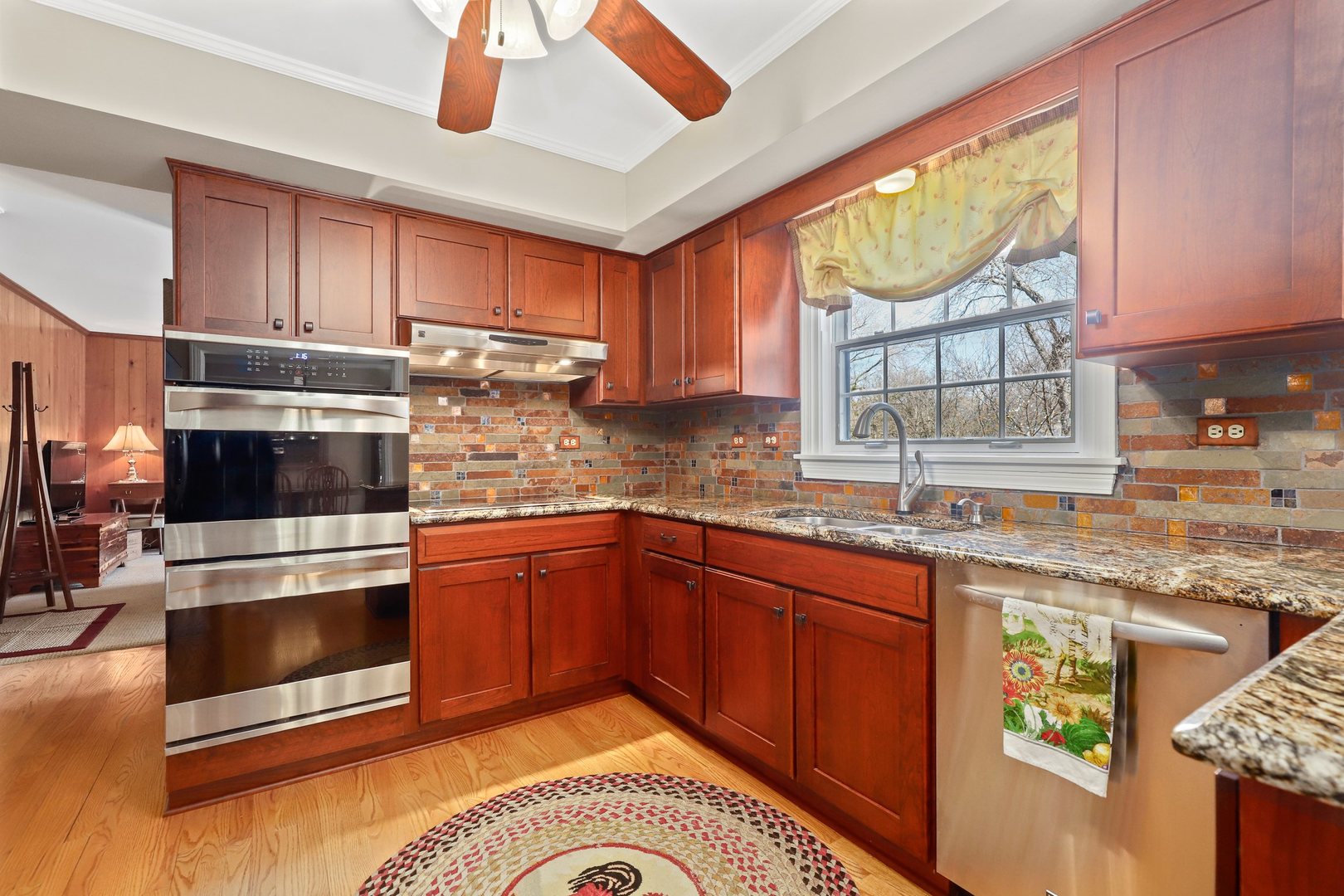 303 Roberts Road Inverness, IL 60067 - Photo 10 of 48 a kitchen with stainless steel appliances granite countertop a stove a sink and a microwave