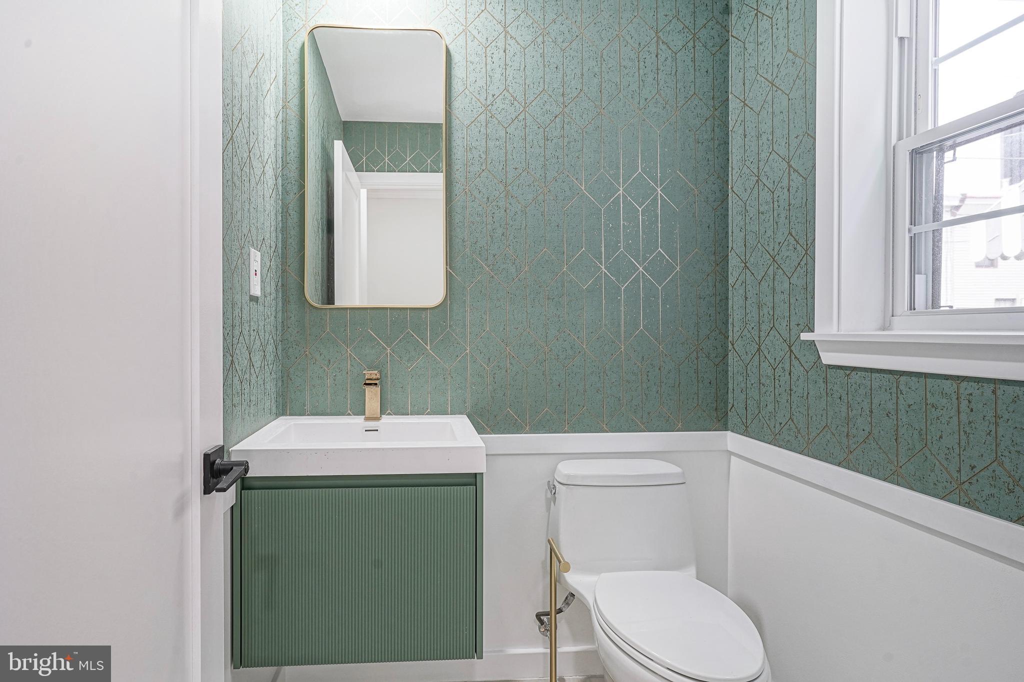 1145 Tasker Street Philadelphia, PA 19148 - Photo 12 of 58 a bathroom with a toilet sink and mirror
