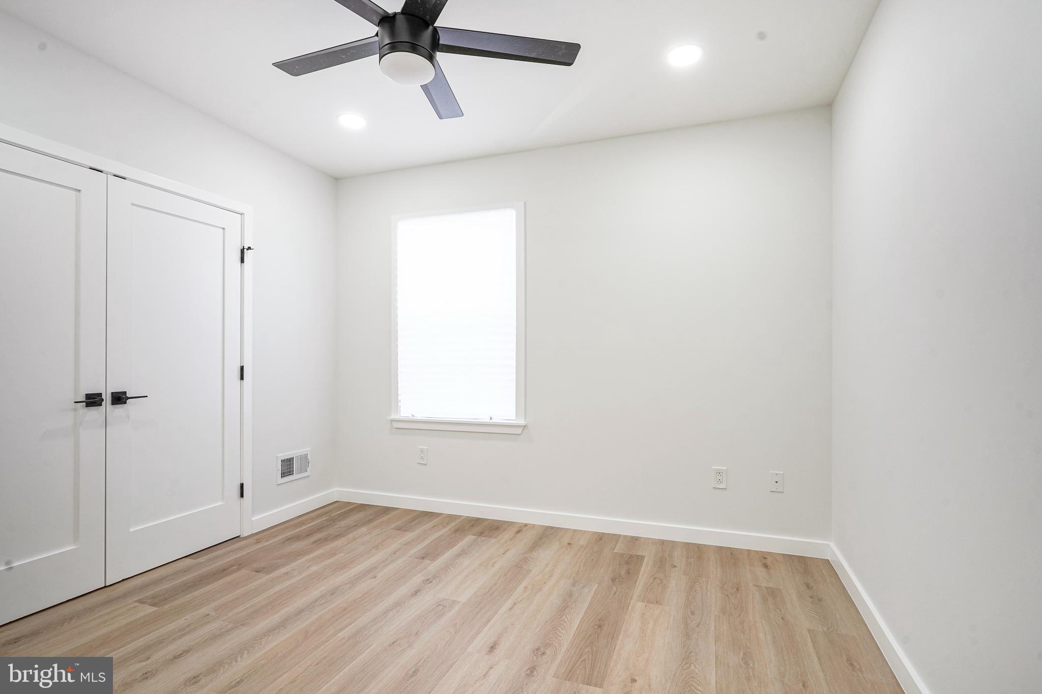 1145 Tasker Street Philadelphia, PA 19148 - Photo 27 of 58 wooden floor in an empty room with a window
