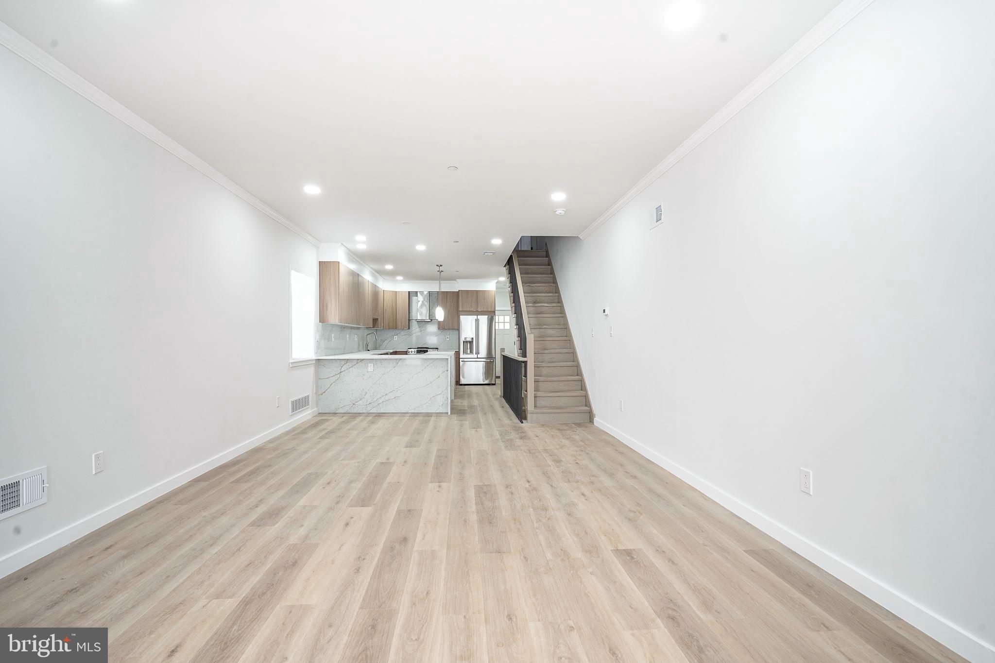 1145 Tasker Street Philadelphia, PA 19148 - Photo 4 of 58 a view of a kitchen with a sink and wooden floor