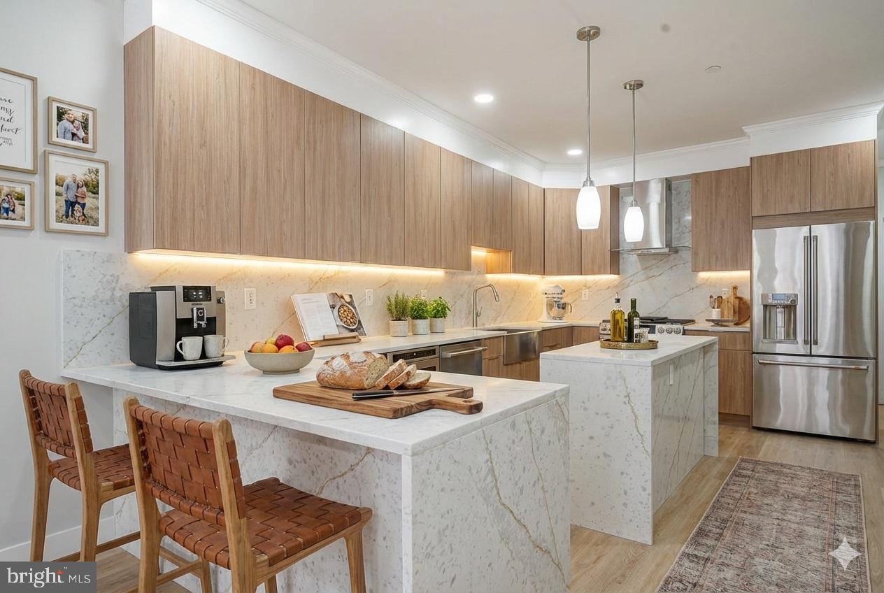 1145 Tasker Street Philadelphia, PA 19148 - Photo 57 of 58 a kitchen with a sink a refrigerator and chairs