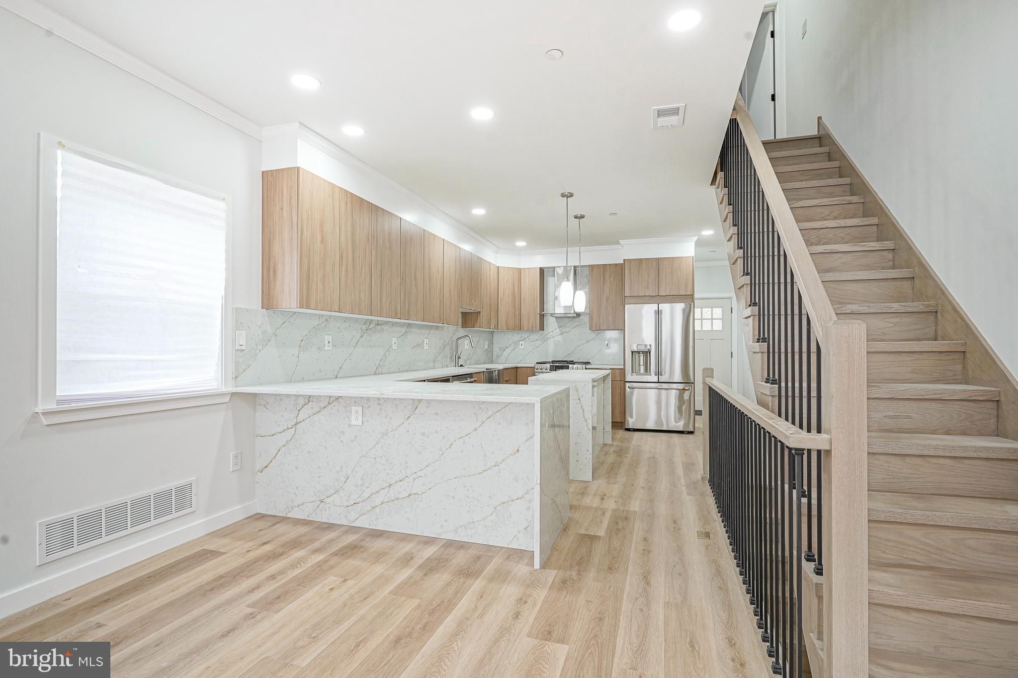 1145 Tasker Street Philadelphia, PA 19148 - Photo 7 of 58 a kitchen with a sink wooden floor and stainless steel appliances
