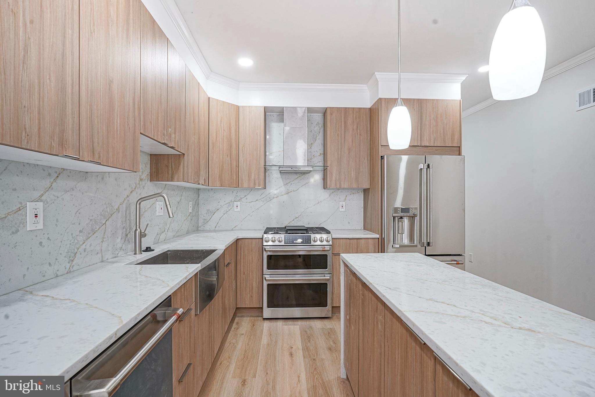 1145 Tasker Street Philadelphia, PA 19148 - Photo 9 of 58 a kitchen with a sink cabinets and stainless steel appliances