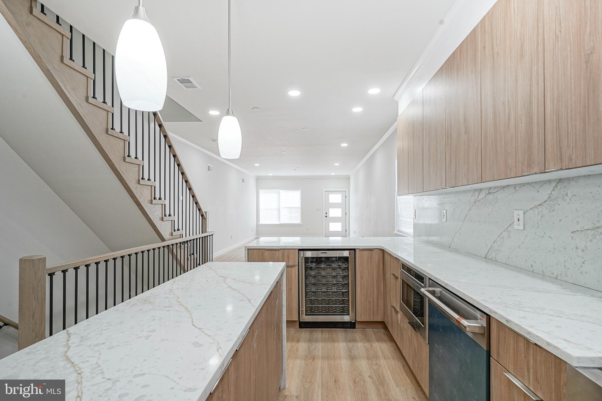 1145 Tasker Street Philadelphia, PA 19148 - Photo 10 of 58 a kitchen with sink cabinets and window